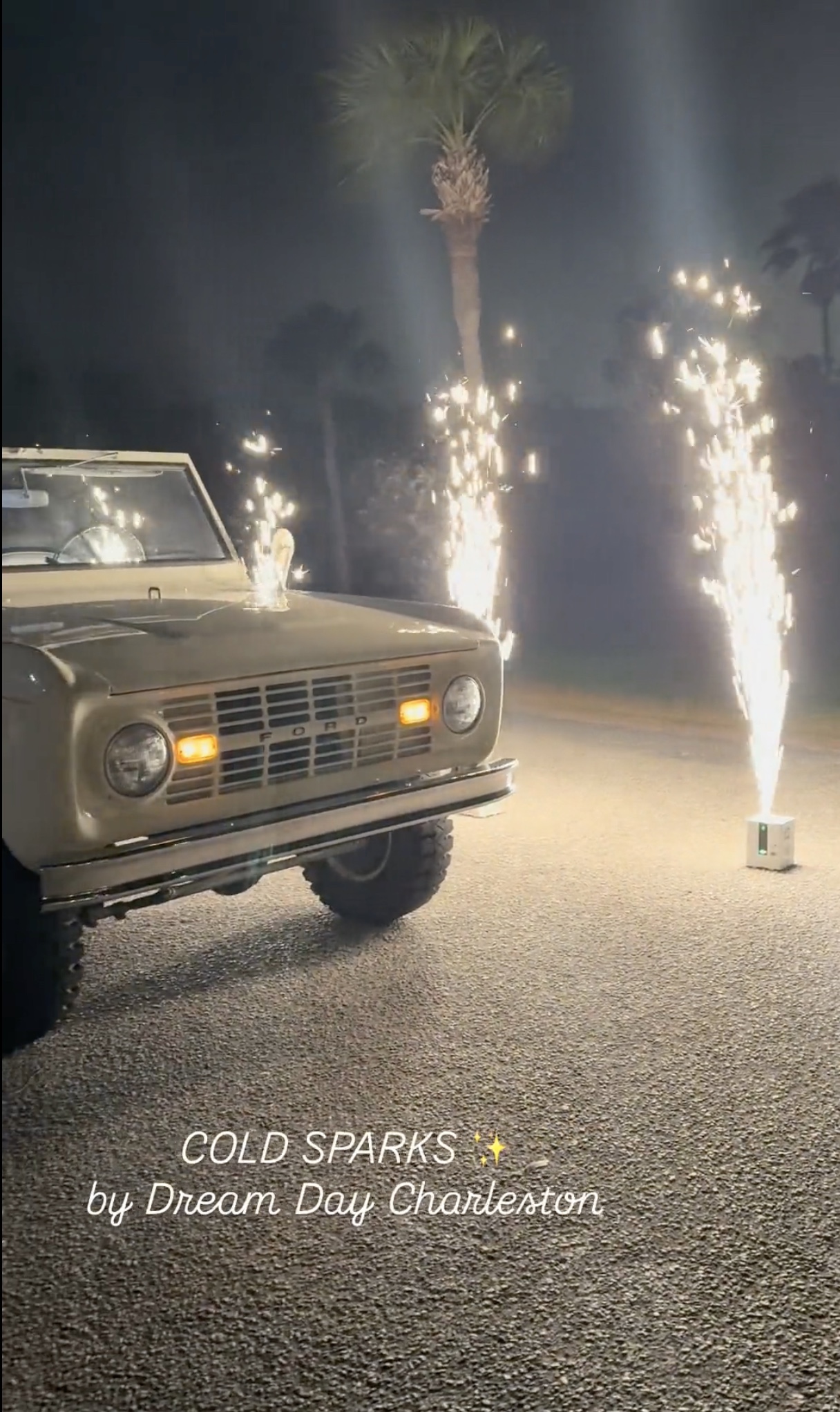Cold Sparks framing a vintage vehicle at an evening wedding send-off